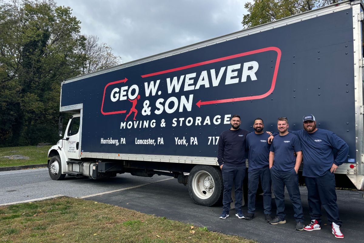 A photo of a Geo W Weaver & Son Moving Crew in front of one of their moving trucks