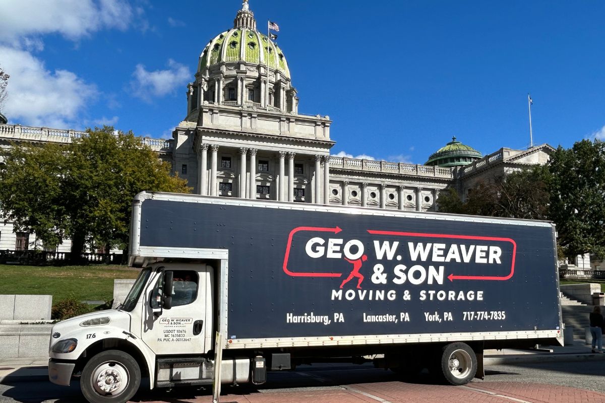 A photo of a Geo W Weaver & Son Moving Truck in front of the PA State Capital in Harrisburg, PA
